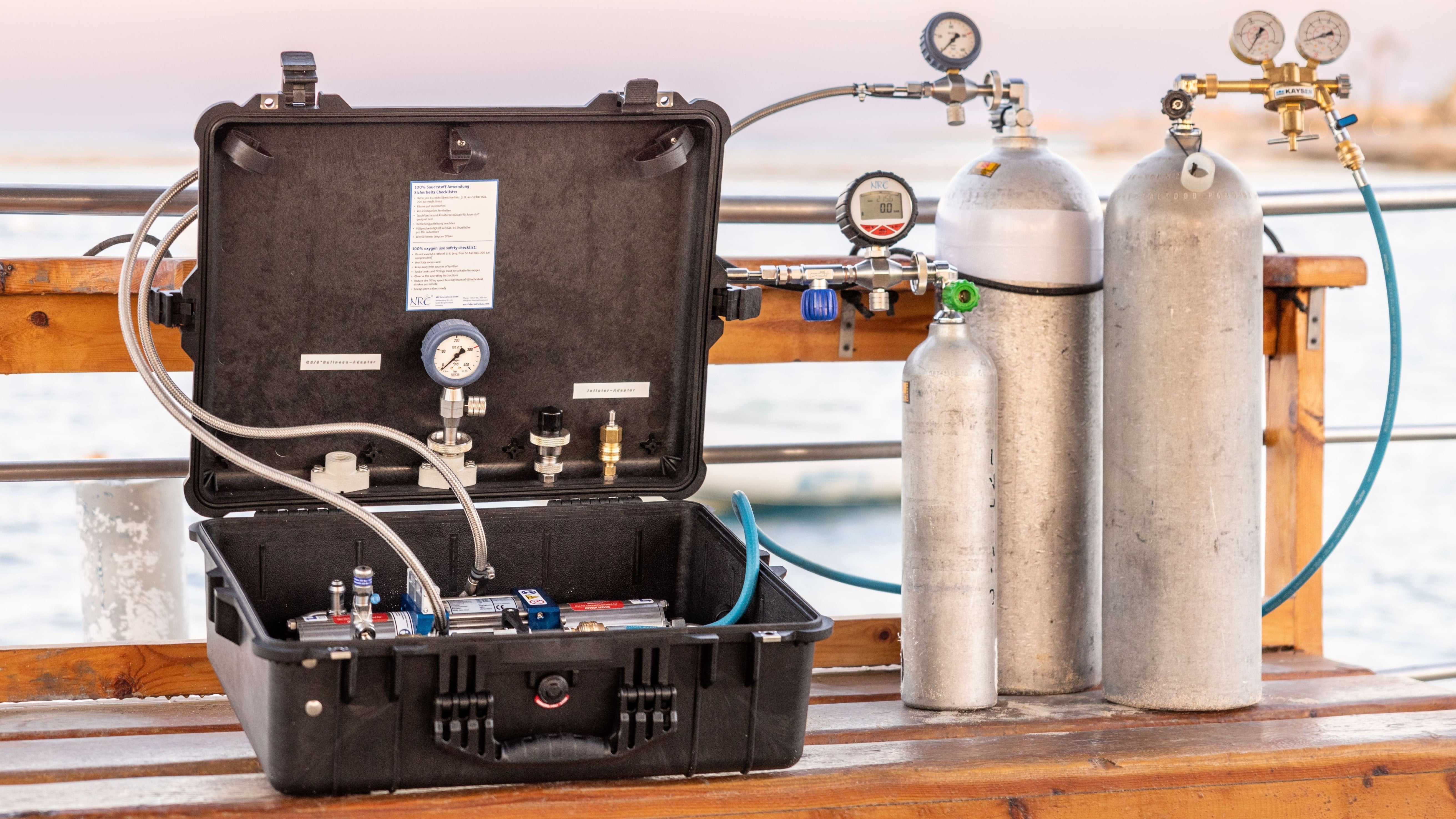 Portable TEC gas booster set transferring helium from supply cylinders to smaller dive tanks, reducing unused gas waste and maximizing helium efficiency during diving gas blending