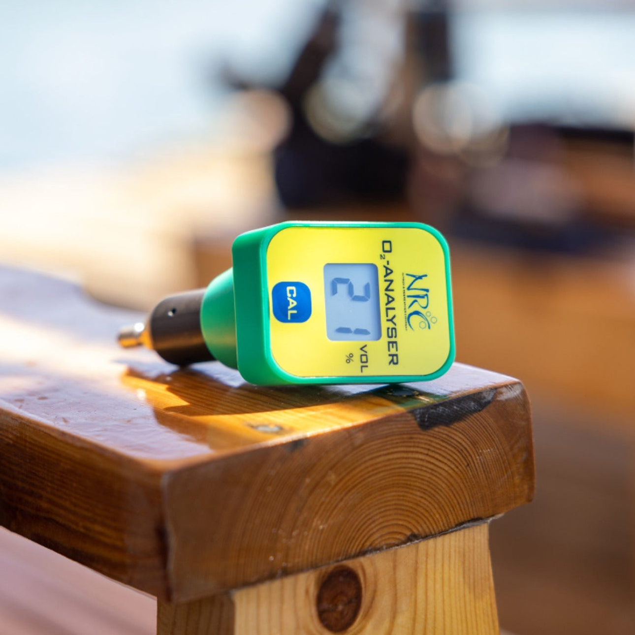 NRC handheld oxygen analyzer displaying 21% O₂, used for verifying breathing gas mixes in diving operations.