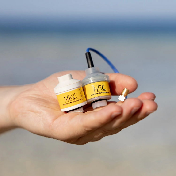NRC oxygen sensors held in hand, used for accurate O₂ measurement in diving analyzers and rebreather systems.