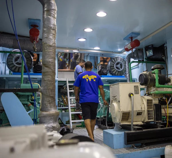 Technician repairing a high-pressure diving compressor